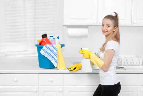 Office cleaners in Wimbledon vacuuming carpets in a corporate workspace