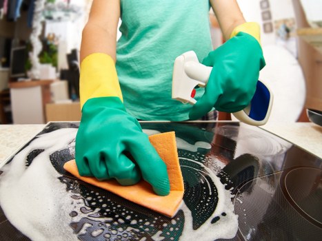 Professional cleaner vacuuming a Wimbledon family home